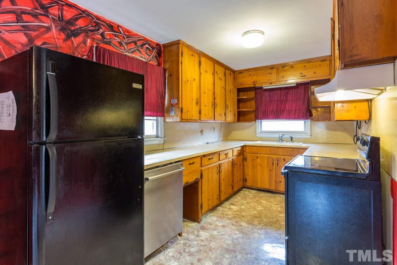 325 Hocutt Road Durham, NC 27703 - Photo 11 of 22 a kitchen with granite countertop a refrigerator and a sink
