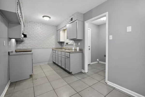a kitchen with stainless steel appliances a sink stove and cabinets