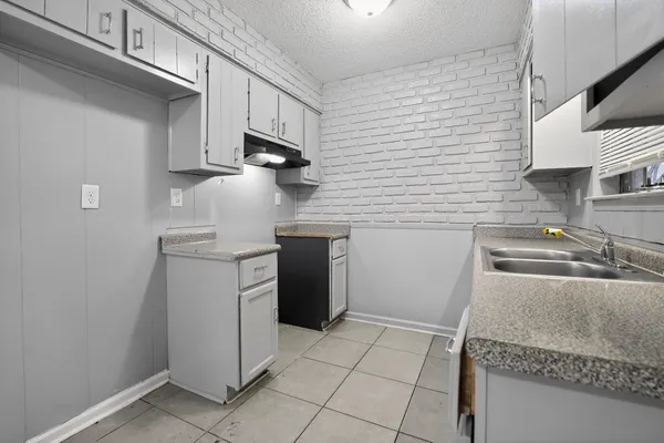 a kitchen with a stove a sink and a refrigerator