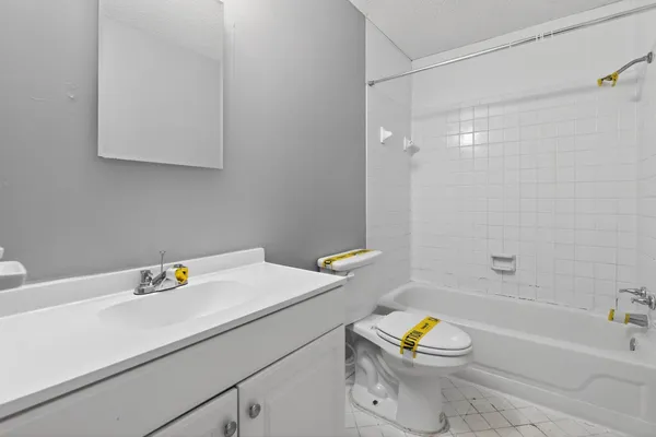 a bathroom with a toilet a sink and bathtub