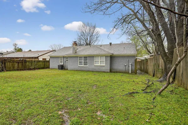 a front view of a house with a big yard