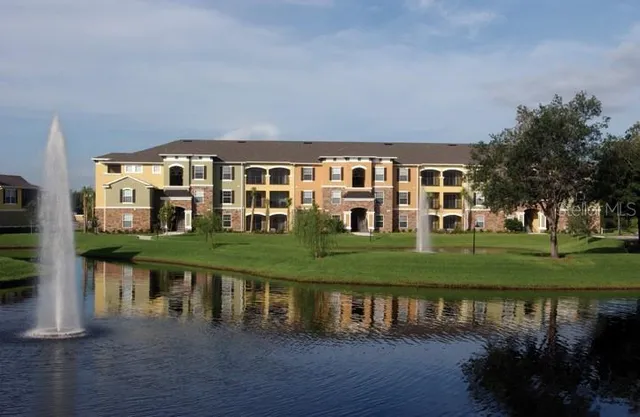 a view of a house with a yard from a lake view