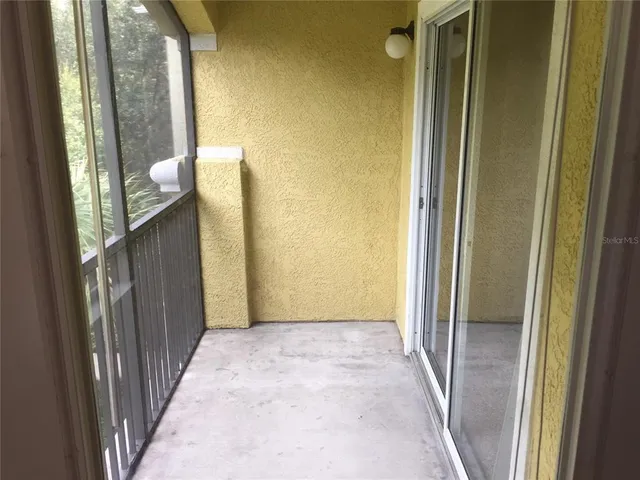 a view of a hallway with windows and entryway