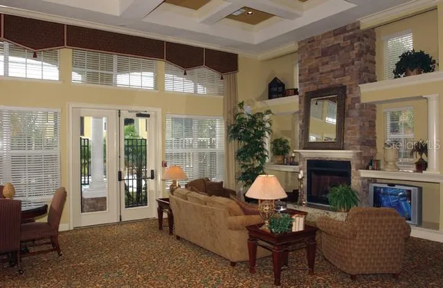 a living room with furniture a fireplace and potted plants