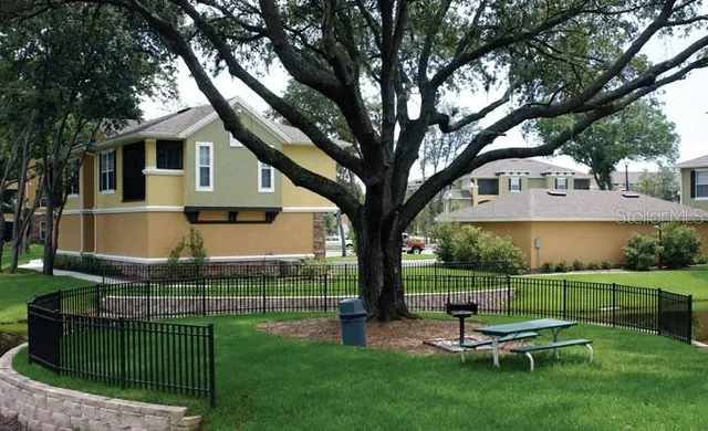 a view of a chair and table in backyard of the house