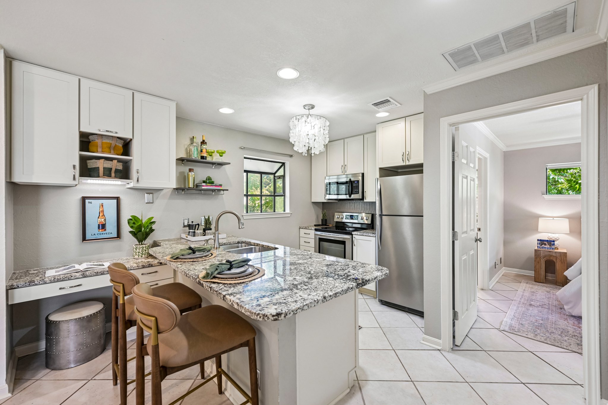 2412 Enfield Road, Unit 8 Austin, TX 78703 - Photo 3 of 34 The remodeled kitchen punches well above its square footage with granite counters, stainless appliances, designer cabinetry, and a breakfast bar made for actual sitting.