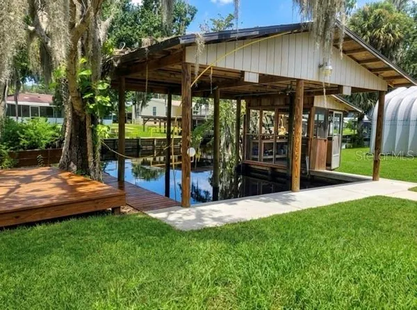 a view of a chair and table in backyard of the house