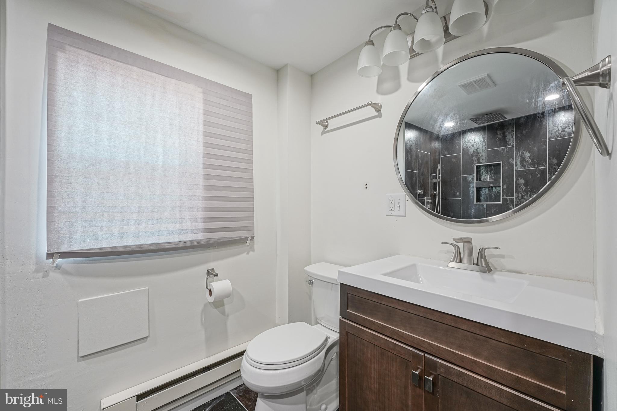 1929 North 9th Street Philadelphia, PA 19122 - Photo 15 of 49 a bathroom with a sink a toilet and mirror