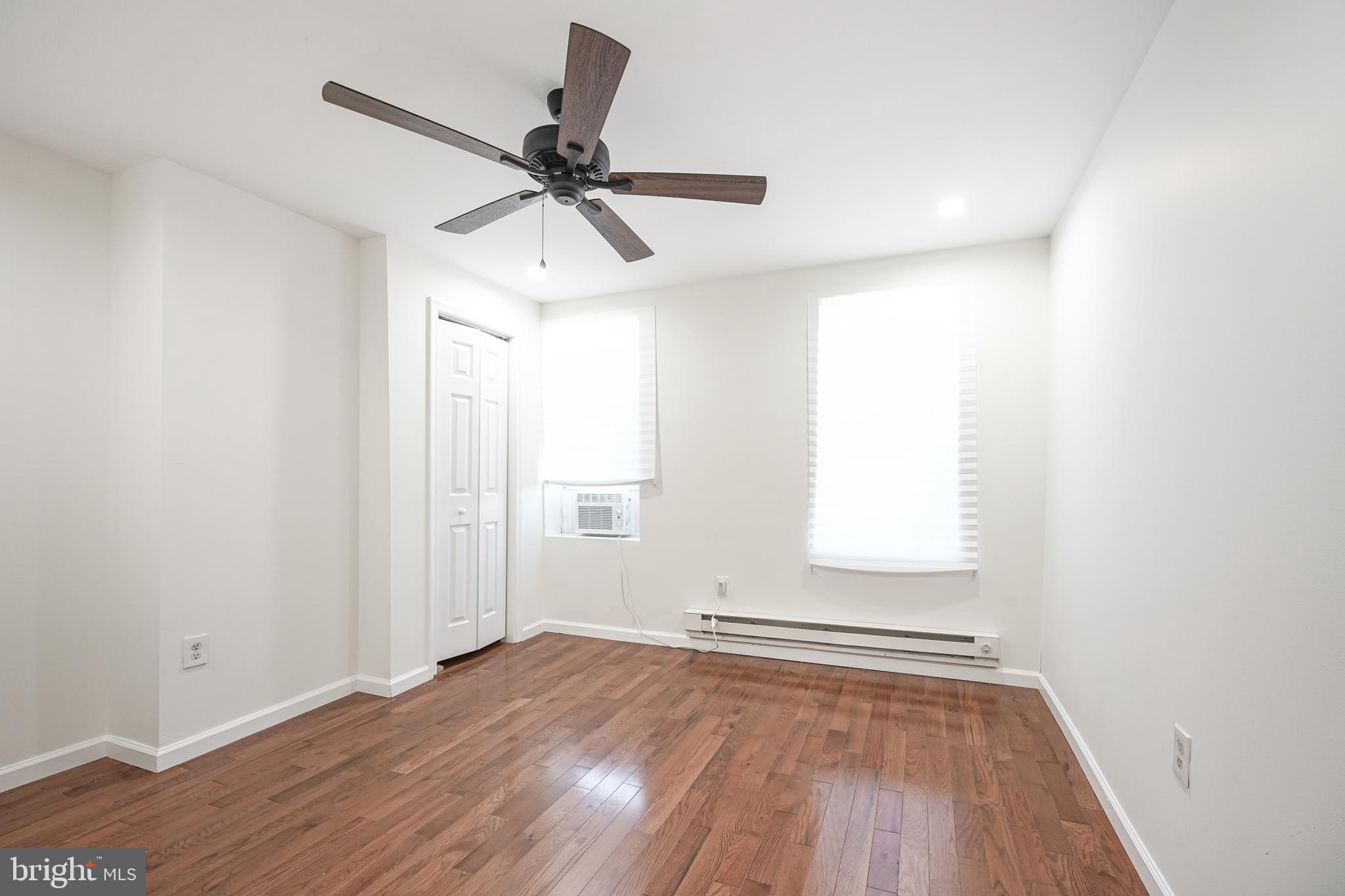 1929 North 9th Street Philadelphia, PA 19122 - Photo 22 of 49 an empty room with wooden floor fan and windows