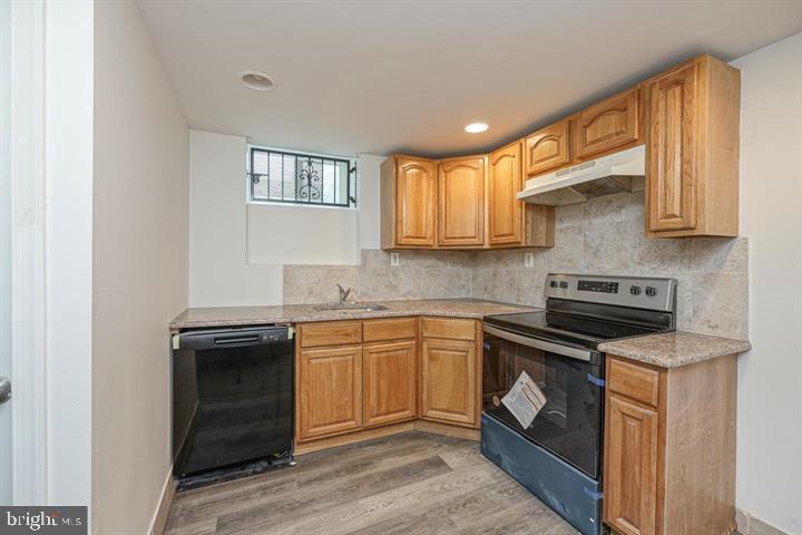 1929 North 9th Street Philadelphia, PA 19122 - Photo 35 of 49 a kitchen with granite countertop cabinets stainless steel appliances and a sink