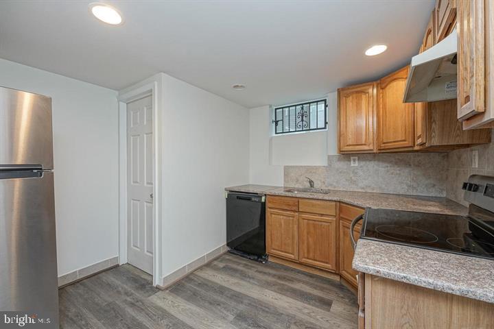1929 North 9th Street Philadelphia, PA 19122 - Photo 36 of 49 a kitchen with stainless steel appliances granite countertop a refrigerator and a sink