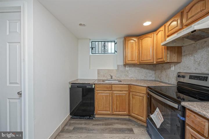 1929 North 9th Street Philadelphia, PA 19122 - Photo 48 of 49 a kitchen with a sink stove and cabinets
