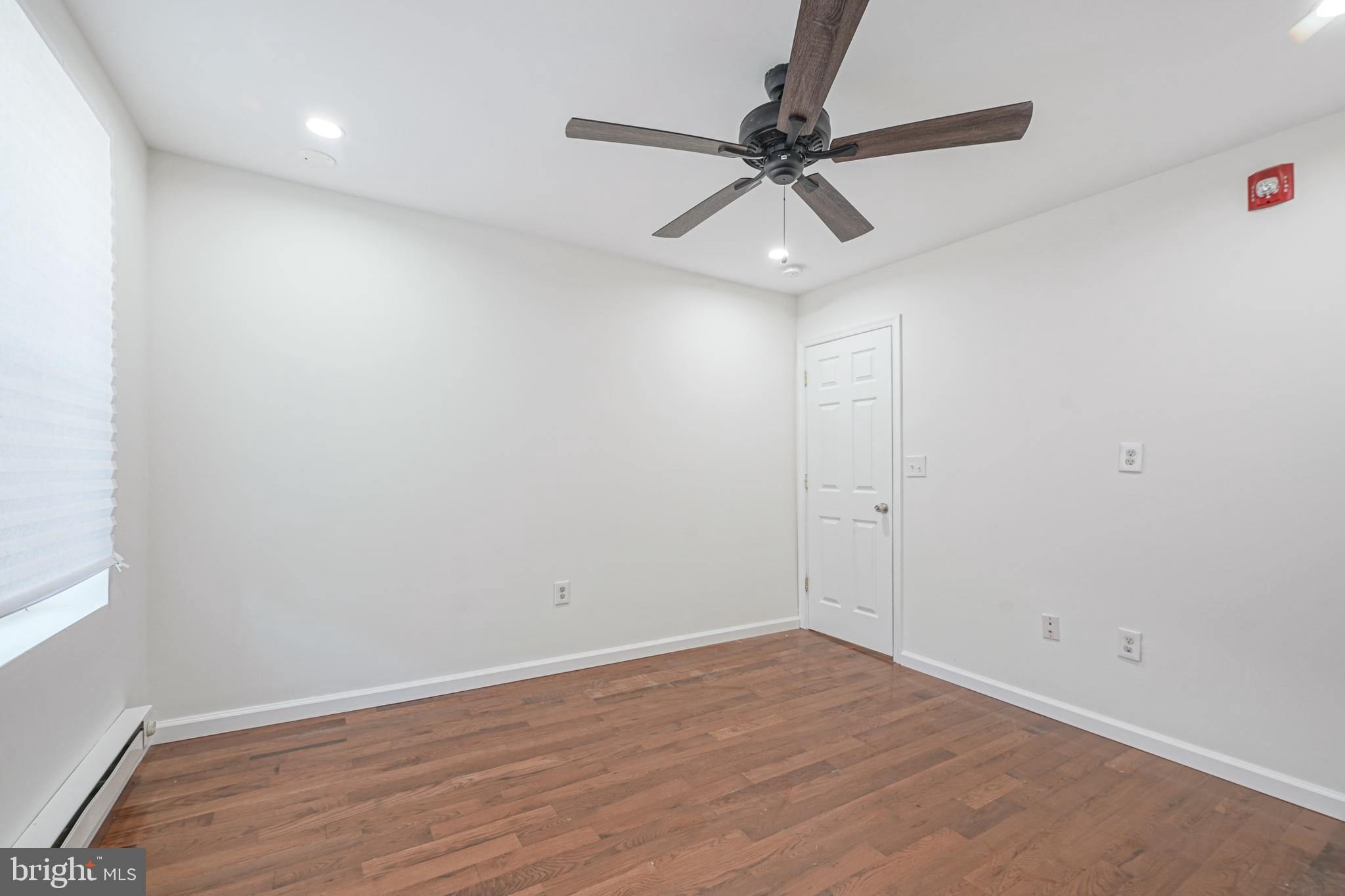 1929 North 9th Street Philadelphia, PA 19122 - Photo 9 of 49 a view of a room with wooden floor and a ceiling fan