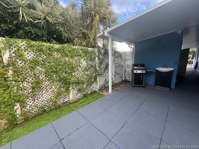 a view of backyard with seating space and trees