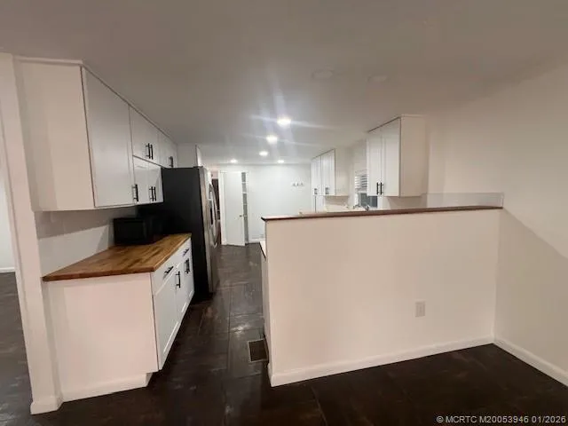 a kitchen with stainless steel appliances a refrigerator and a stove top oven