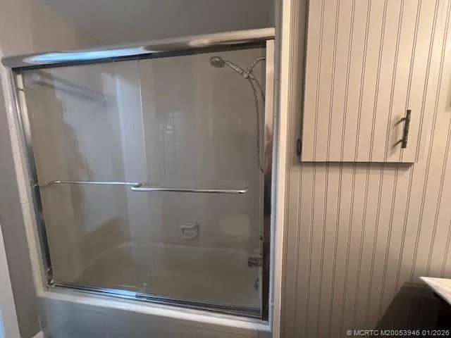 a bathroom with a glass shower door