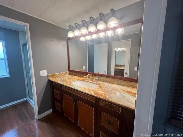 a bathroom with a granite countertop sink a large mirror and vanity