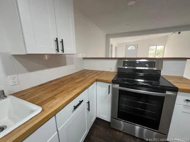 a kitchen with granite countertop a stove and a sink
