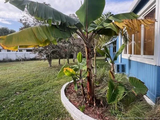 a view of a house with porch and garden
