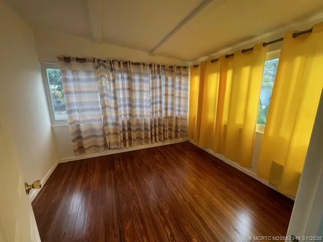 a view of wooden floor and brick walls