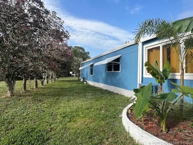 a view of a backyard with large trees
