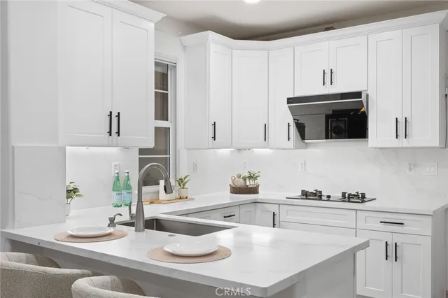 a living room with furniture potted plant and a fireplace