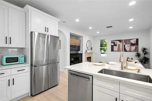 a dining room with furniture a potted plant and a sink
