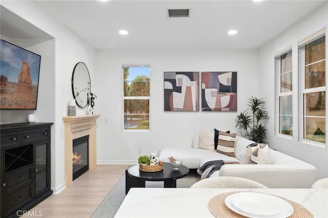 a view of a dining room with furniture and a potted plant