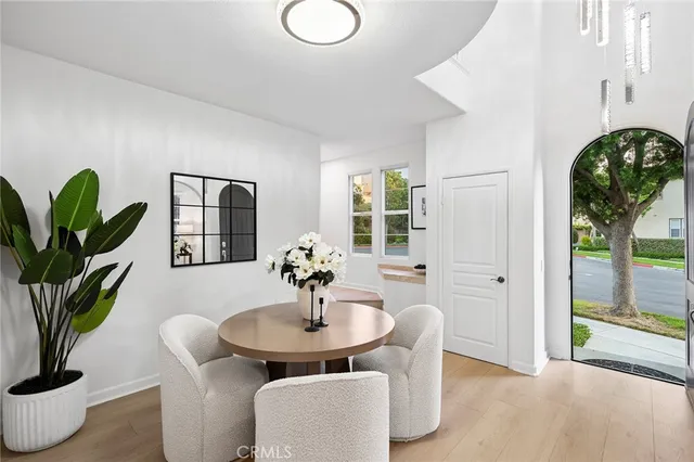 a living room with furniture a table and a potted plant