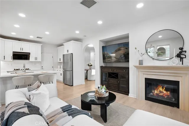 a kitchen with stainless steel appliances kitchen island granite countertop a dining table and chairs