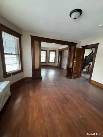 wooden floor in an empty room with a window
