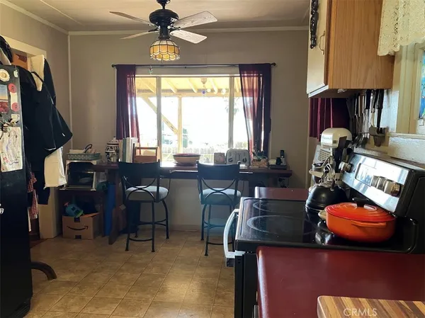 a bedroom with a bed painting on wall and a large window