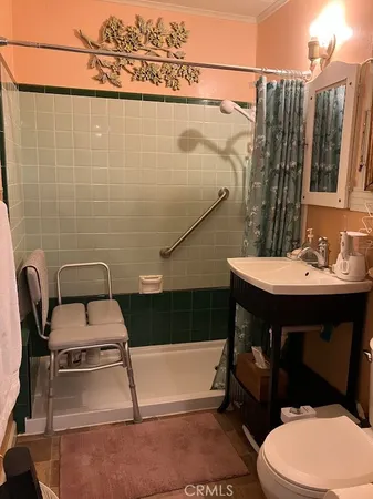 a bedroom with a bed and a mirror on the dresser