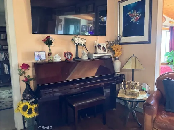 a view of a balcony with chairs and a potted plant