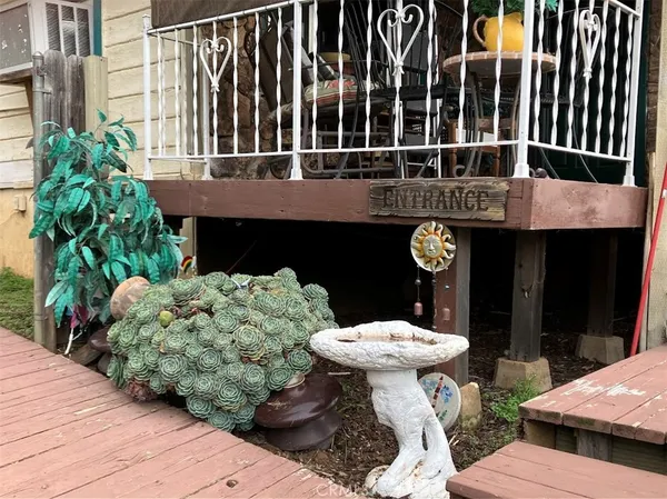 a front view of a house with a yard and a garden