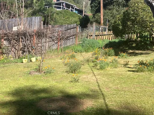 a backyard of a house with a yard and outdoor seating