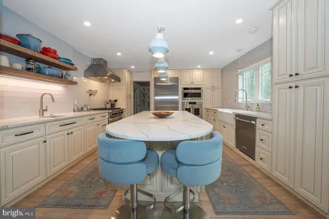 a kitchen with cabinets and stainless steel appliances