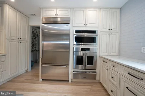 a kitchen with stainless steel appliances a stove and cabinets