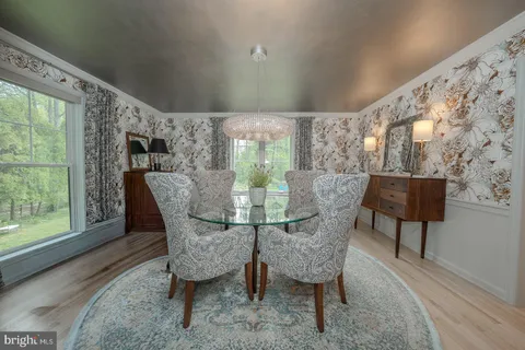 a spacious bedroom with a bed a window and a chandelier