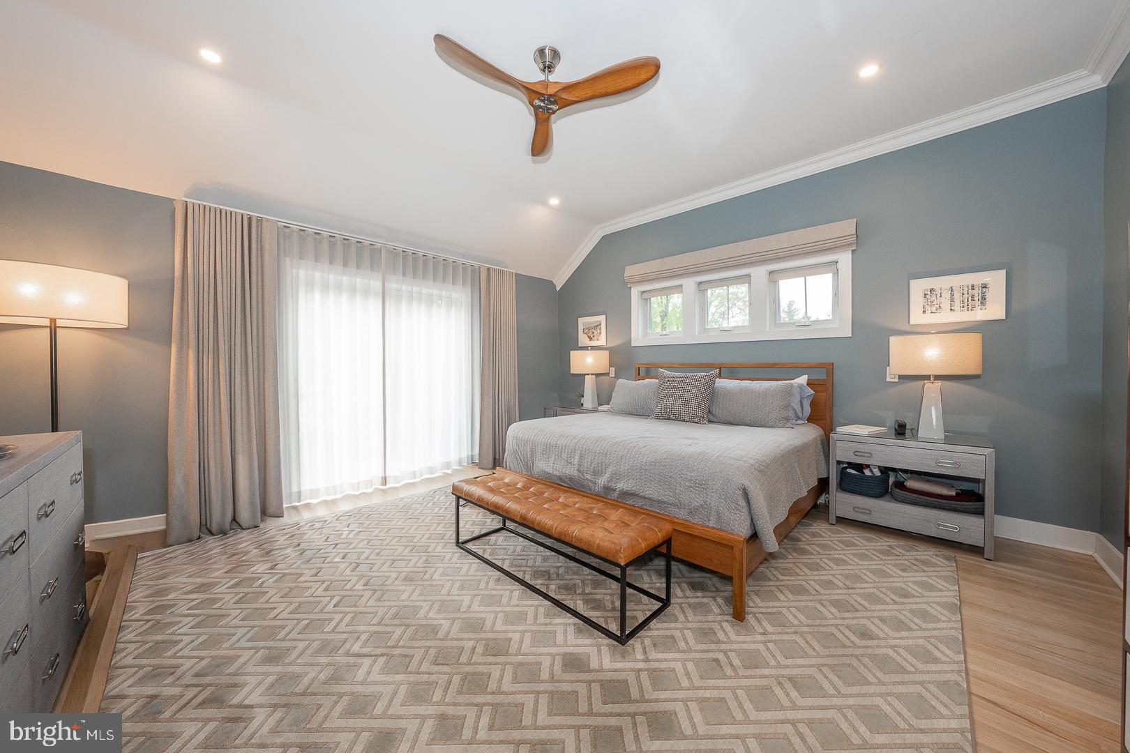 945 Lafayette Road Bryn Mawr, PA 19010 - Photo 22 of 53 a spacious bedroom with a bed a window and a chandelier