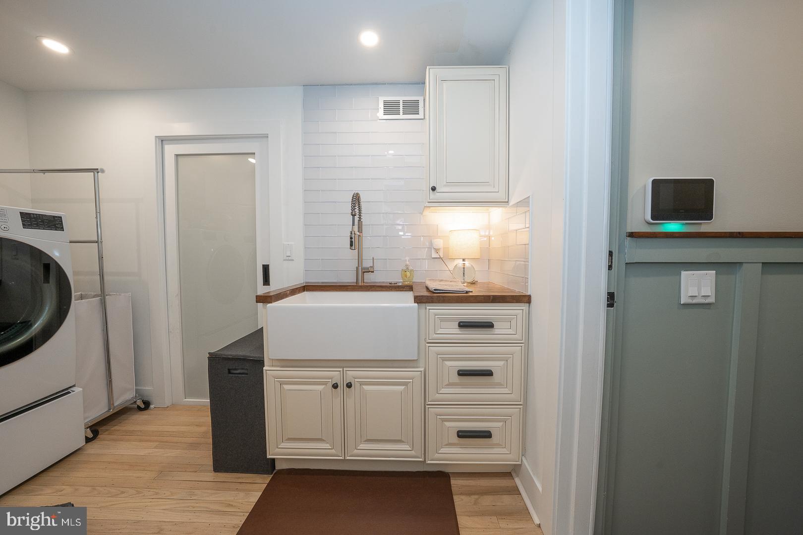 945 Lafayette Road Bryn Mawr, PA 19010 - Photo 30 of 53 a kitchen with a refrigerator sink and cabinets