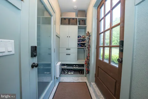 a view of entryway and hall with wooden floor