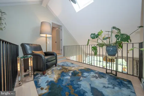a living room with furniture and a mirror