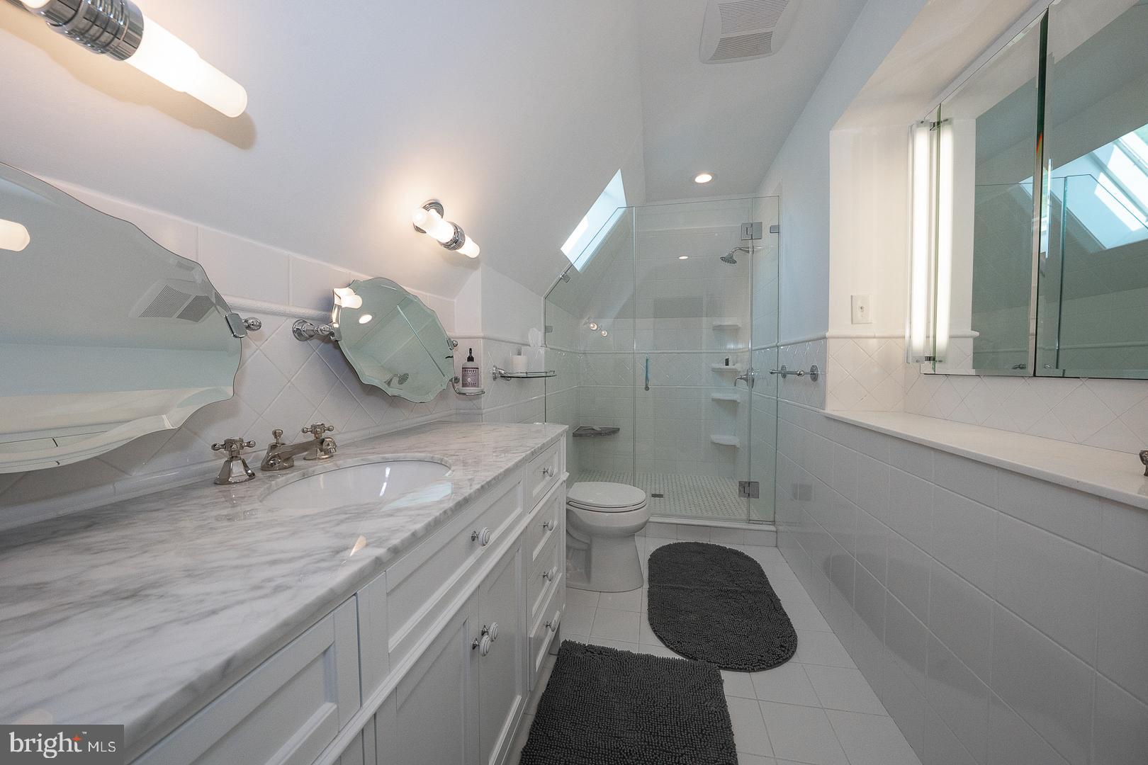 945 Lafayette Road Bryn Mawr, PA 19010 - Photo 36 of 53 a bathroom with a granite countertop sink a toilet and shower