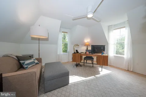 a bedroom with a bed a mirror and a window