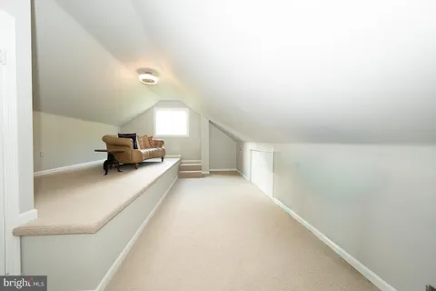 a living room with fireplace furniture and a window