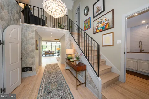 a view of entryway and hall with wooden floor