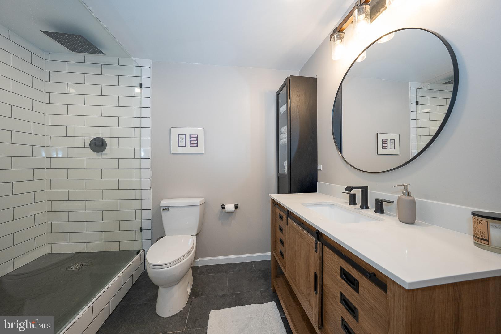 945 Lafayette Road Bryn Mawr, PA 19010 - Photo 45 of 53 a bathroom with a sink a toilet and a mirror