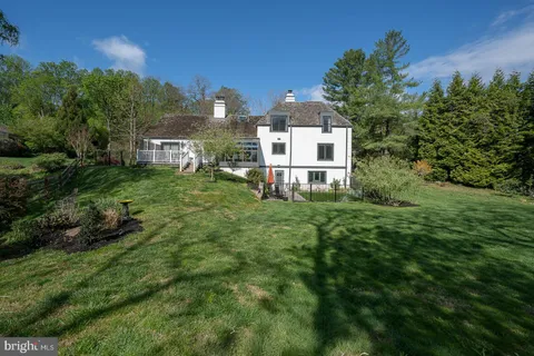 a view of a house with a yard lake and outdoor space