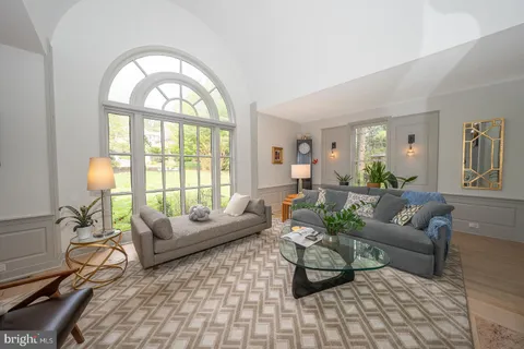 a living room with furniture a couch and a potted plant